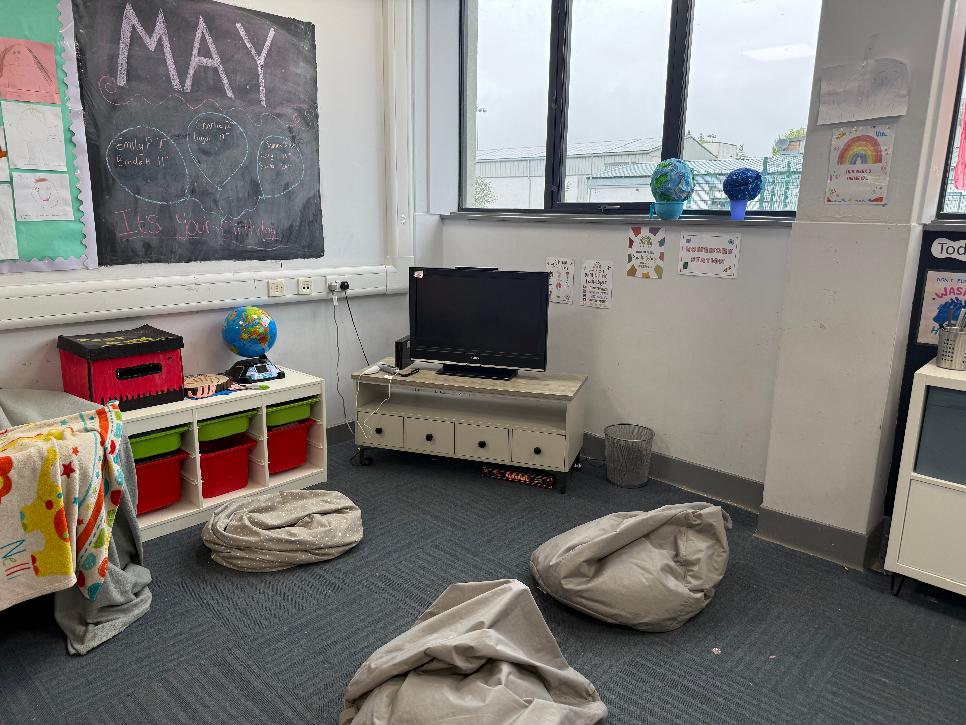 Cosy chill-out corner with bean bags, chalkboard and TV