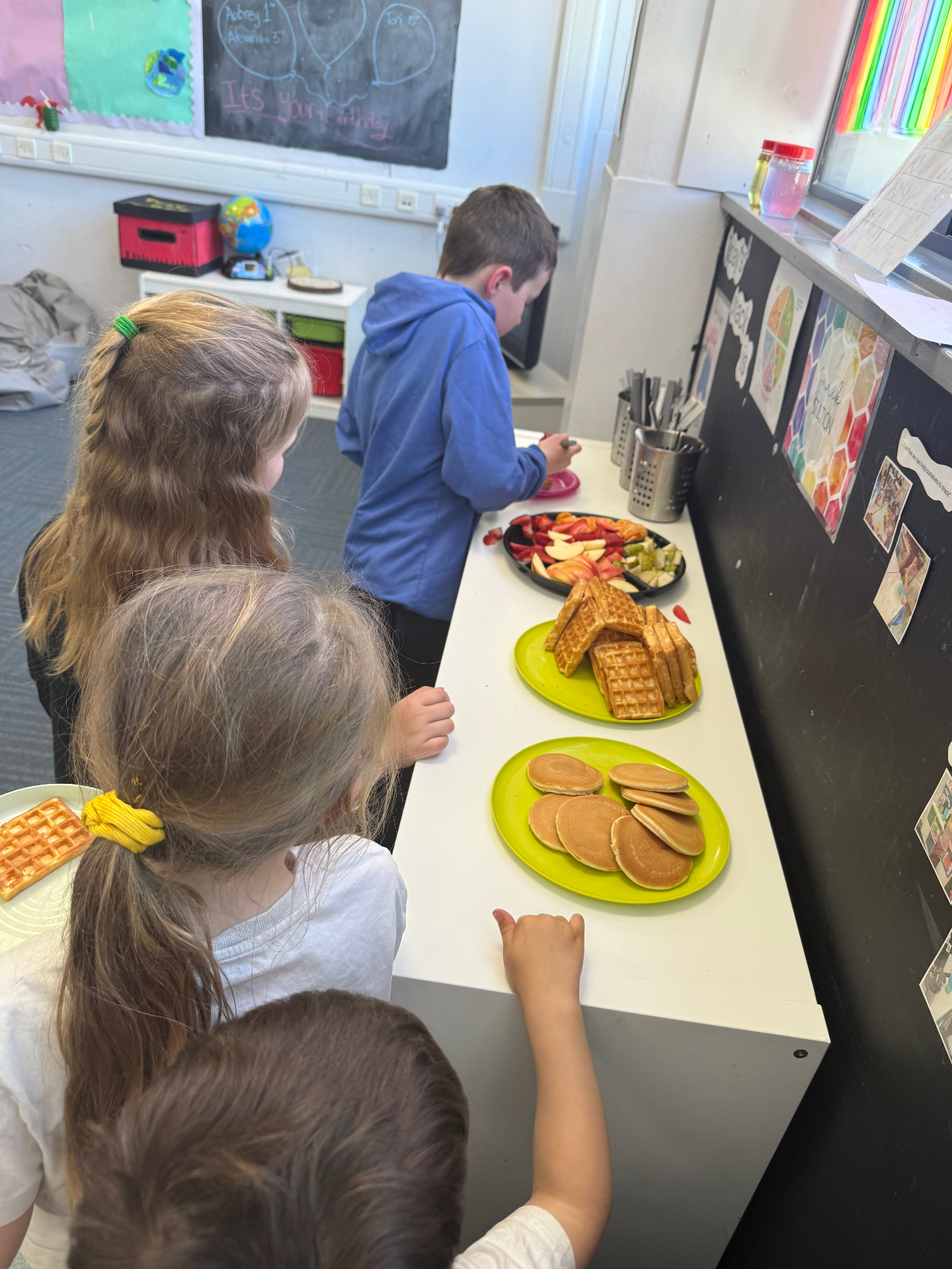 Children enjoying snacks together at AllSorts