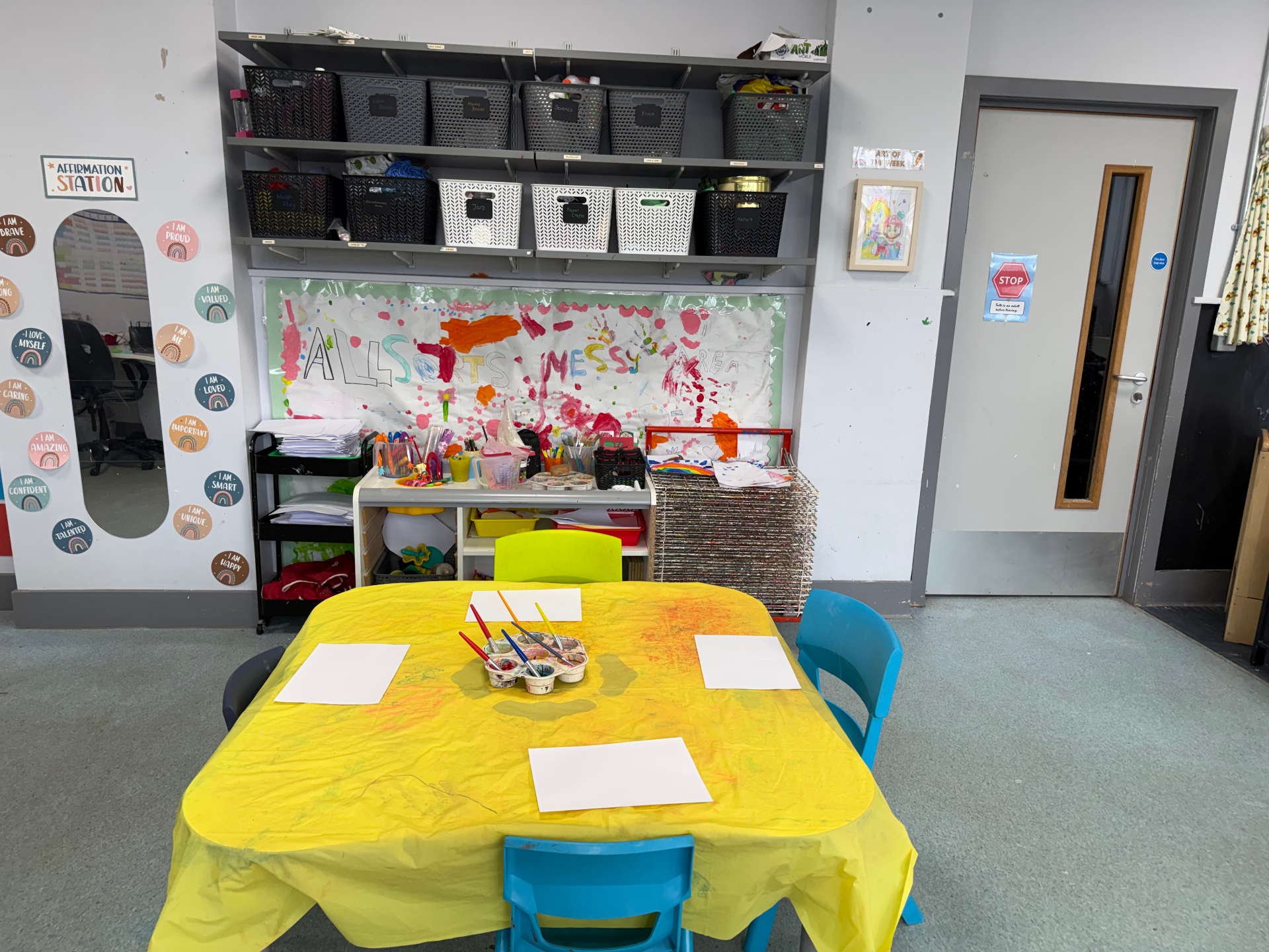Messy art area with affirmation station and paint table